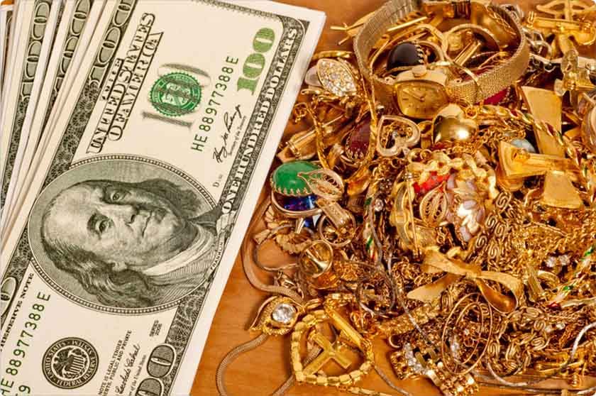 USA dollars and golden jewelry on a table